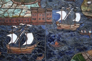 A detail: little rowing boats ply across the river with sailing ships in full sail.