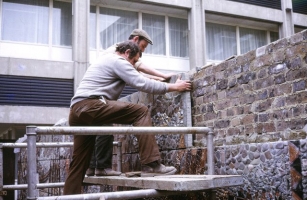 The ceramic and stone has been transported to site and imbedded into cement on top of concrete blocks. Workmen now fix the panels back to the wall. - click to enlarge The ceramic and stone has been transported to site and imbedded into cement on top of concrete blocks. Workmen now fix the panels back to the wall.