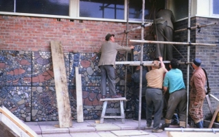 The ceramic and stone having been laid in cement applied to 3’ square concrete blocks, they are hoisted into position using rope and tackle. Note the foreman in his hat giving a guiding hand. Not too much health and safety in evidence in 1963. - click to enlarge The ceramic and stone having been laid in cement applied to 3’ square concrete blocks, they are hoisted into position using rope and tackle. Note the foreman in his hat giving a guiding hand. Not too much health and safety in evidence in 1963.
