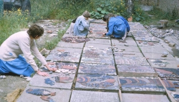 The pieces having been made over many months, they are now assembled together with the stones on the surface of the blocks. Here a 6th former is arranging ceramic with a group of much younger children also at work in the background. - click to enlarge The pieces having been made over many months, they are now assembled together with the stones on the surface of the blocks. Here a 6th former is arranging ceramic with a group of much younger children also at work in the background.