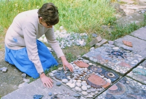 The sixth former has made and glazed an almost life-size figure of a queen. Here she arranges the head on a 2’ square concrete block. - click to enlarge The sixth former has made and glazed an almost life-size figure of a queen. Here she arranges the head on a 2’ square concrete block.