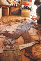 At the right hand side of the mural school children are seen at play. Here the figures are seen lying on the floor of my London studio. They have been modelled in red clay and cut into pieces. We are picking up the pieces for drying and ‘biscuit firing’ in the kiln. - click to enlarge At the right hand side of the mural school children are seen at play. Here the figures are seen lying on the floor of my London studio. They have been modelled in red clay and cut into pieces. We are picking up the pieces for drying and ‘biscuit firing’ in the kiln.