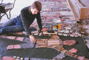 The other assistant places the figure of a footballer into the wet render. The adjacent blocks have been completed. - click to enlarge The other assistant places the figure of a footballer into the wet render. The adjacent blocks have been completed.