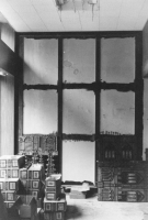 Wooden battens - painted black to hide the joints - were screwed to the office wall to receive the nine panels. Two panels have already been fixed to the wall.