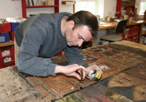 Mending the damaged mural - click to enlarge Mending the damaged mural