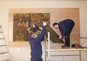 Lifting the fourth panel into place - There seem to be 3 hands and one man helping to heave up the panel - click to enlarge Lifting the fourth panel into place - There seem to be 3 hands and one man helping to heave up the panel