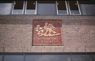 Bird watermark panel on Rushmoor Court.