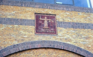 The Symbol of Justice watermark panel on The Courtyards. The only panel remaining as of May 2016.