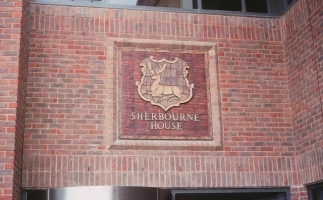 A stag watermark panel on Sherbourne House.