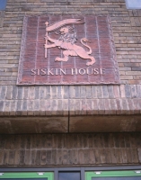 The Lion watermark panel on Siskin House.