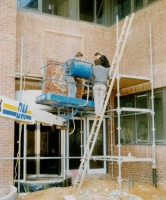 Lifting the Sherbourne House watermark panel into position to be fixed on the wall.