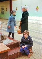 A bored looking young Daniel with sister and grandmother admiring the toads.