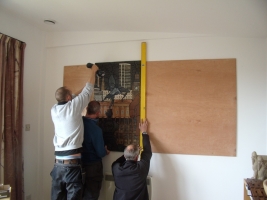 Workmen putting up the mural