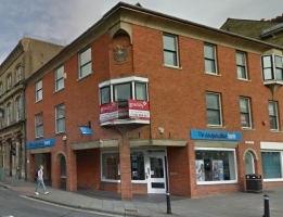 Image from Google Streetview (May 2014) showing the crest high up on the corner of the Co-Operative Bank.